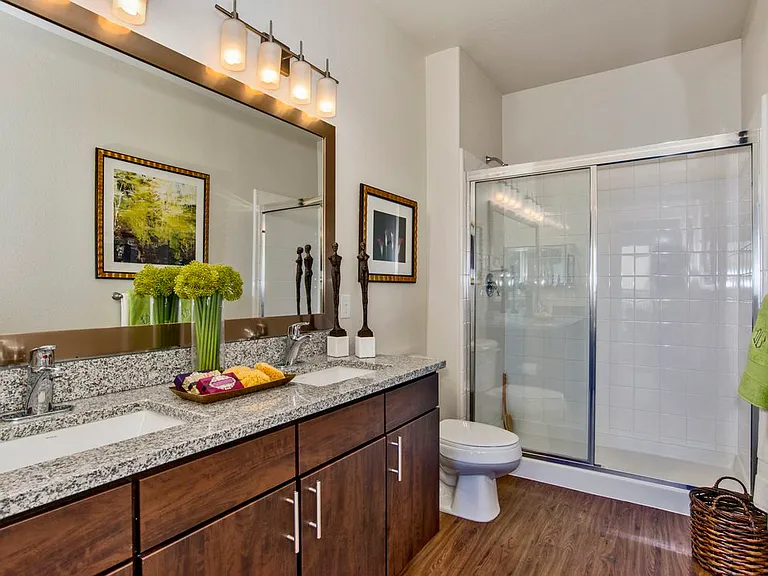 Classic Package I bath with espresso cabinetry, speckled granite countertops, and hard surface flooring