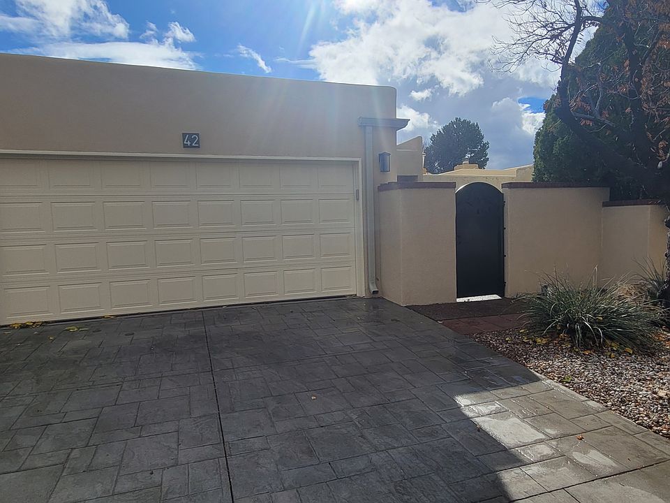 Front of townhouse. 2 car garage. Gate to courtyard.