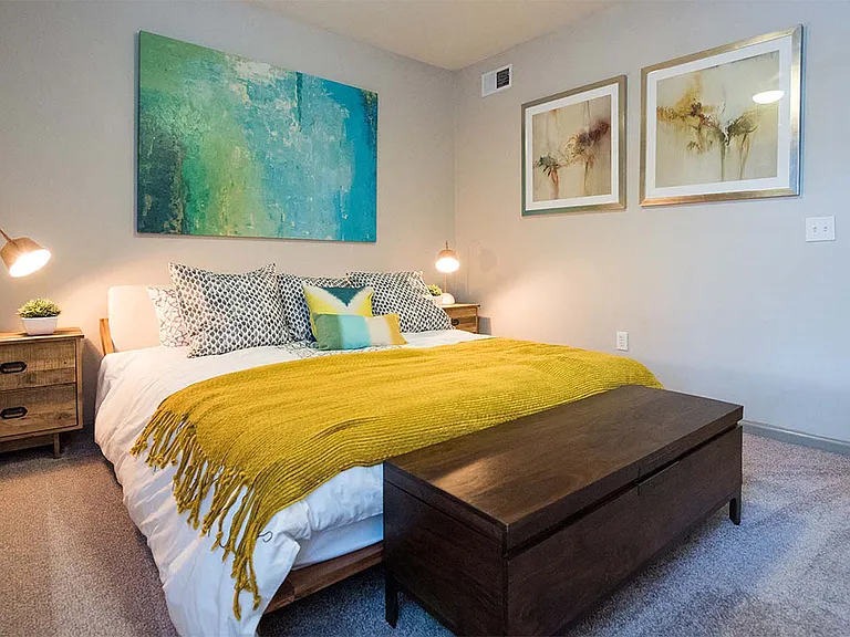 Spacious apartment bedroom with carpeted floors.