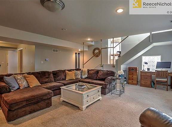 MAIN FAMILY ROOM LIVING AREA WITH LOADS OF SUNLIGHT AND BACK STAIRCASE.