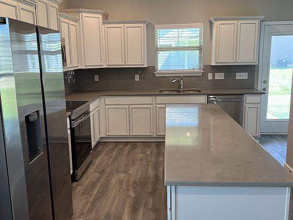 Kitchen features are complete 4-pieces of S S appliances. quartz kitchen counter tops island w