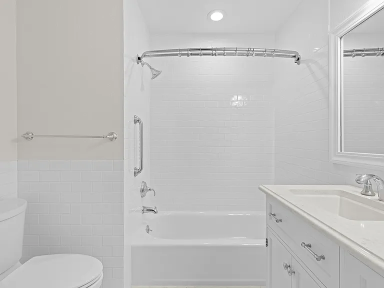 The upstairs secondary bathroom features an updated vanity, generous cabinet and storage space, and a tub/shower combination.