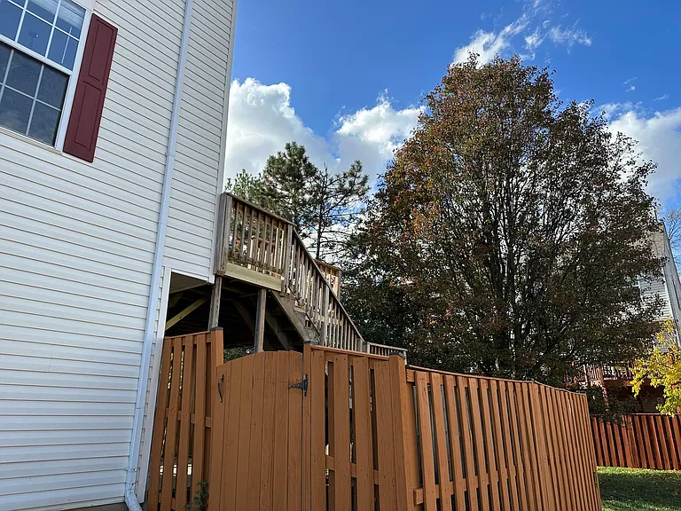 View from side yard looking up to the upper deck - back yard is fully fenced in