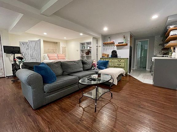 Living Room/Bedroom - wood laminate flooring - recessed lighting - open floor plan