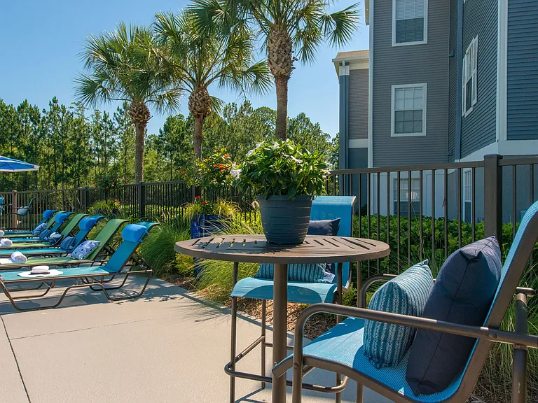 Relax in style with plentiful poolside tables and lounge seating.
