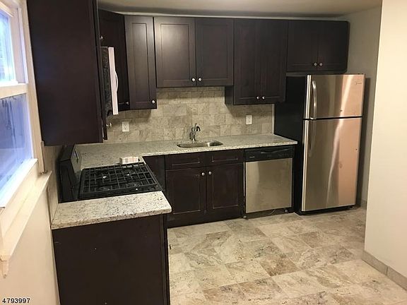 Beautiful new kitchen with stainless steel appliances, wood 