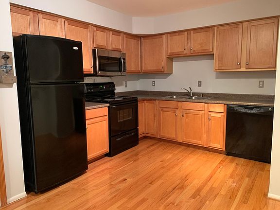 Kitchen with black and ss appliances