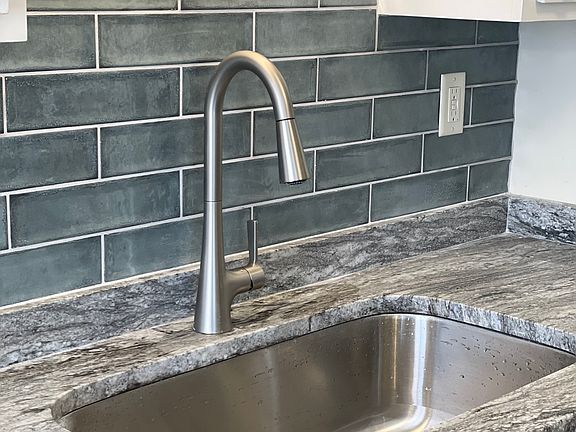 Granite countertops and decorative tiled backsplash