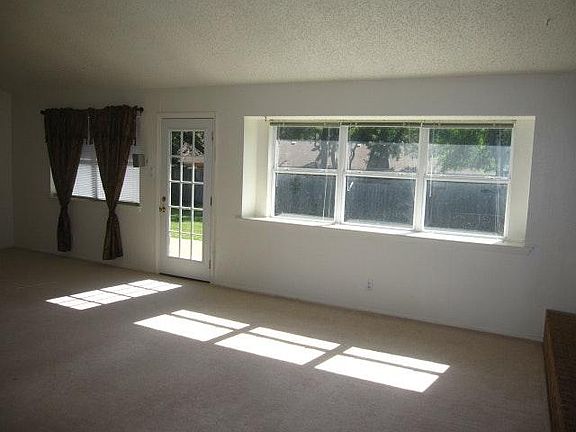 Combined living and dining. Wall decoration or drapes are no