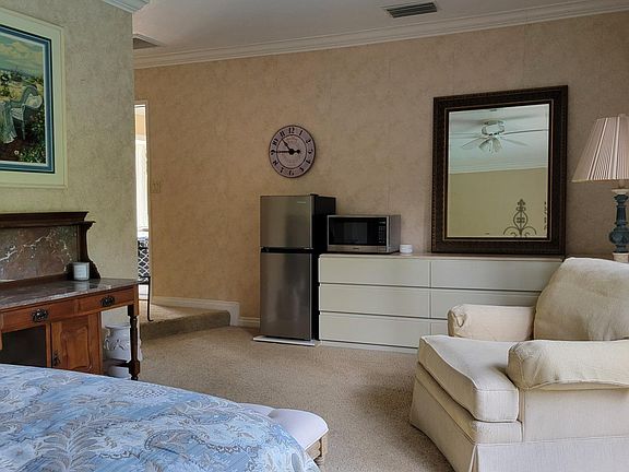Showing the fridge, microwave and sitting area set up.