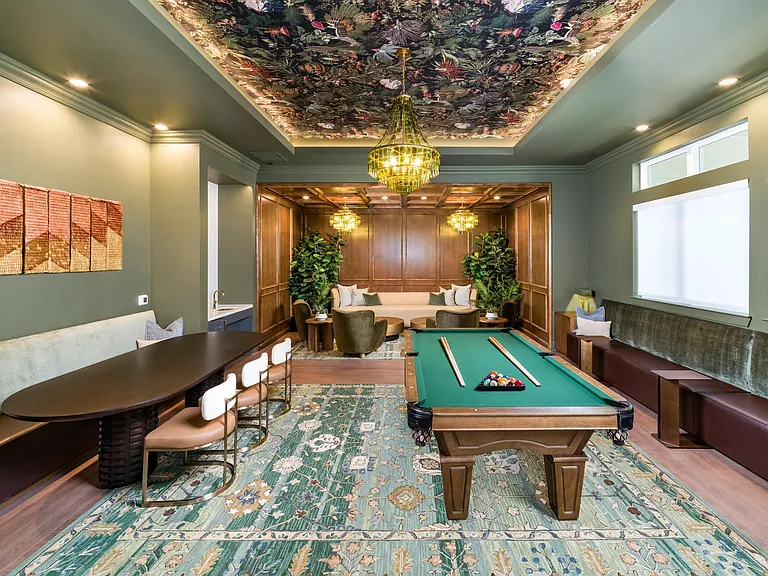 The Parlor features a billiards table, shared seating, and rich finishes set beneath a patterned ceiling and statement lighting.