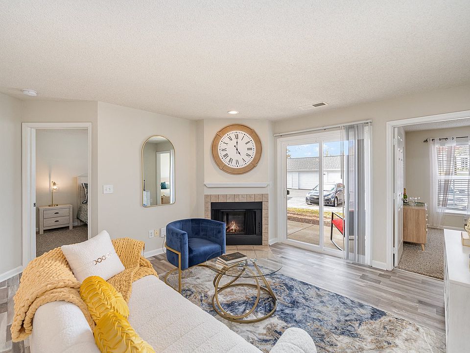 Living Room with Fireplace and Woodgrain Flooring