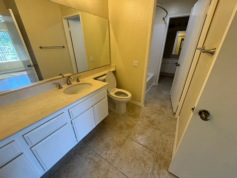 Master bathroom with doorway to shared shower