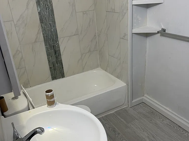 Downstairs Bath with Tiled Shower and Pergo Flooring taken from Doorway