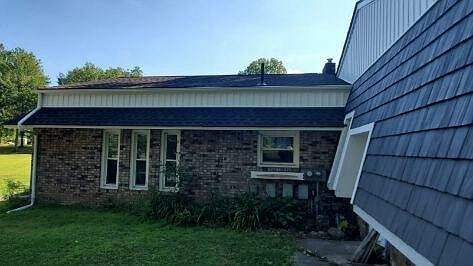 Front of unit showing windows in living area and kitchen. Roof and siding recently replaced.
