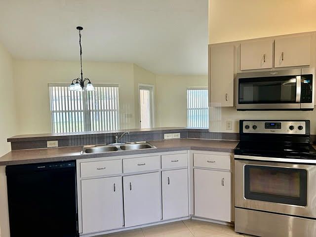 Kitchen with microwave, stove and dishwasher