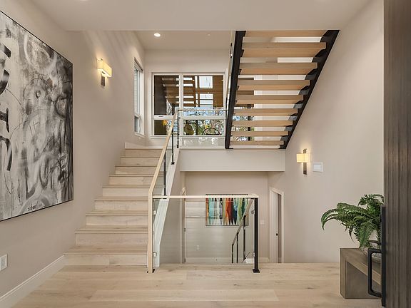 Soaring interiors and a dramatic floating staircase meet wonderfully integrated spaces.