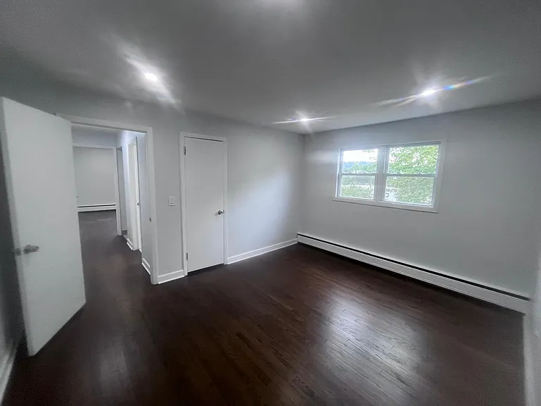 bedroom two, lots of light, faces side of property, two closets