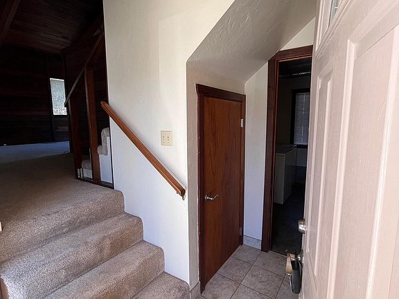 Entryway. Stairs lead to living room. Straight leads to laundry room.