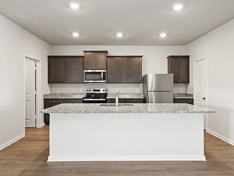 The kitchen has beautiful wood cabinetry.