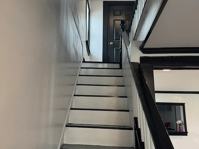 Beautiful Black and White Staircase leading downstairs to first floor