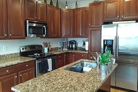 Kitchen with island, stainless steel, granite, cherry cabinets