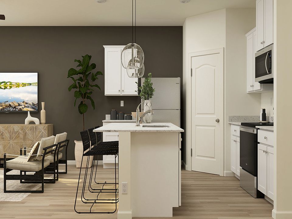 The kitchen of the Hilgard has white wood cabinetry.