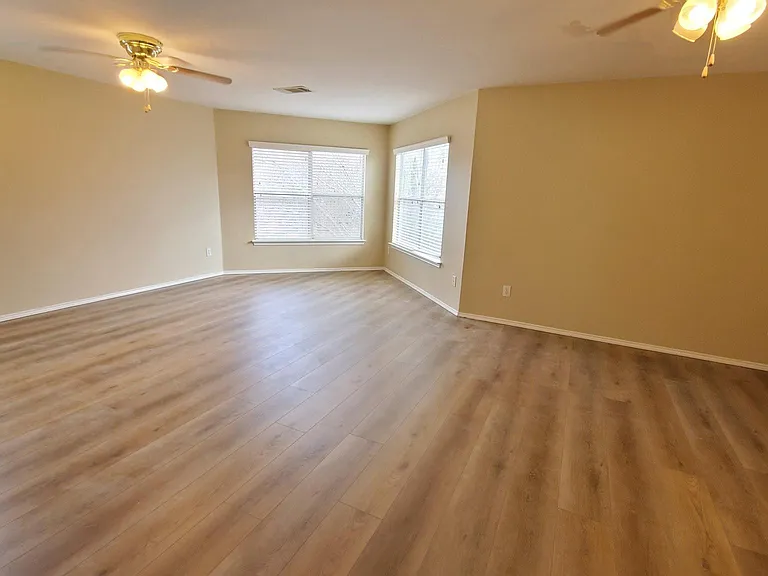 Main bedroom with windows and extra seating/flex areas.