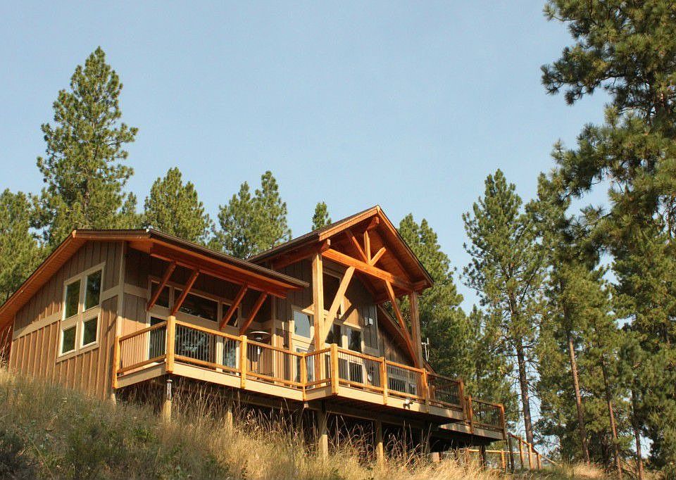 Perched on a gently sloping hillside that borders the nature conservancy.