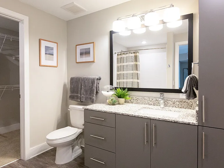 Spacious spa-inspired bathrooms with polished chrome hardware and fixtures.