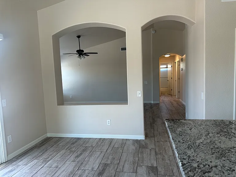 Open dining area looking into the living room and down the hall to the bedrooms.