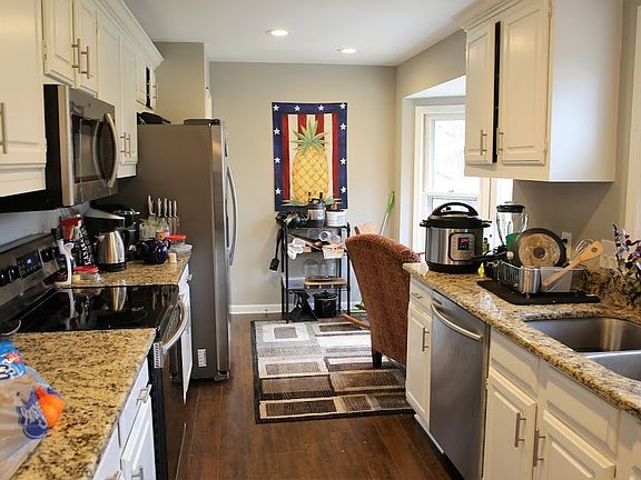 Here's the kitchen, which leads to a small breakfast nook. On the opposite site is a dining room next to the deck that overlooks the woods and small lake.
