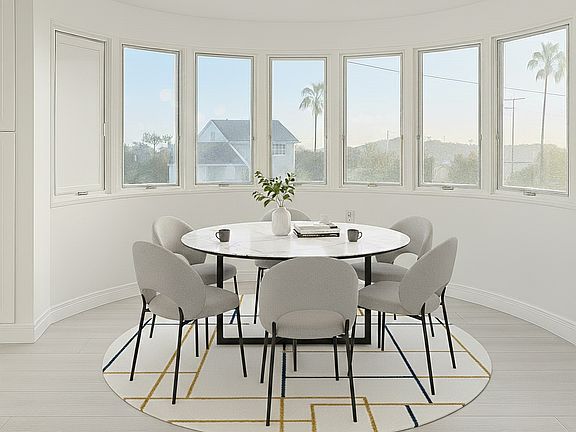 An airy, light-filled dining nook with lovely views_perfect for enjoying morning coffee or sharing warm meals with family and friends.