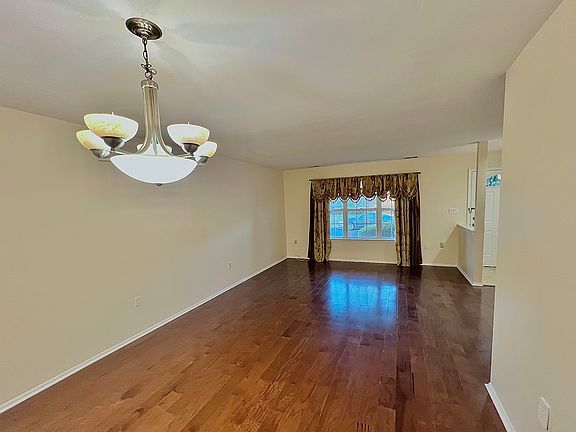 Open concept formal living and dining room, featuring newly installed hardwood floors