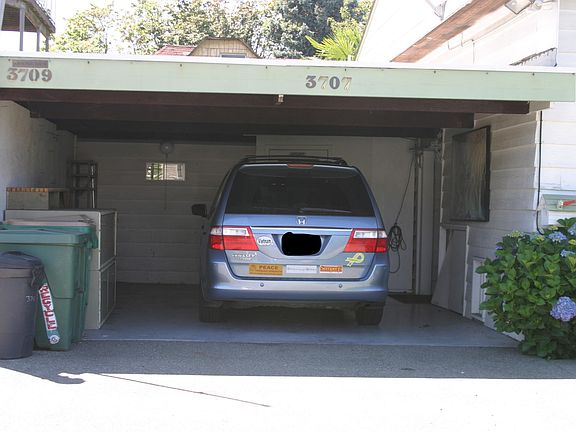 It really is a Large carport. The small window looks into the shop which has large windows and lighting for its workbench. The top of the door to it and the laundry room is visible above and behind the van. That is a large storage piece and shelving be