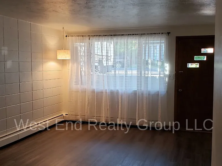 Mid century style living room with original block wall and front door.