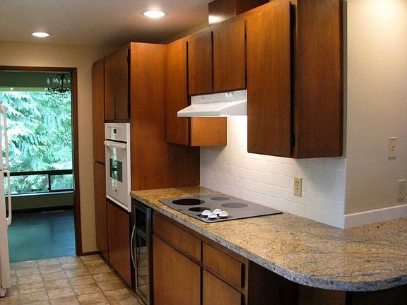 Kitchen with new granite countertop and wine refrigerator