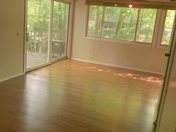 Living, dining el with sliding glass door to deck.