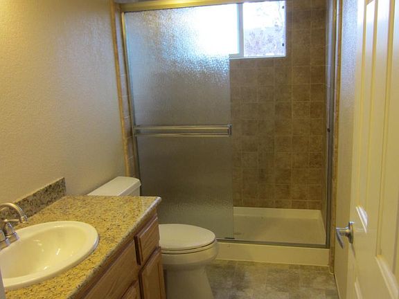 Bathroom has a new stone shower, cabinets and a granite coun