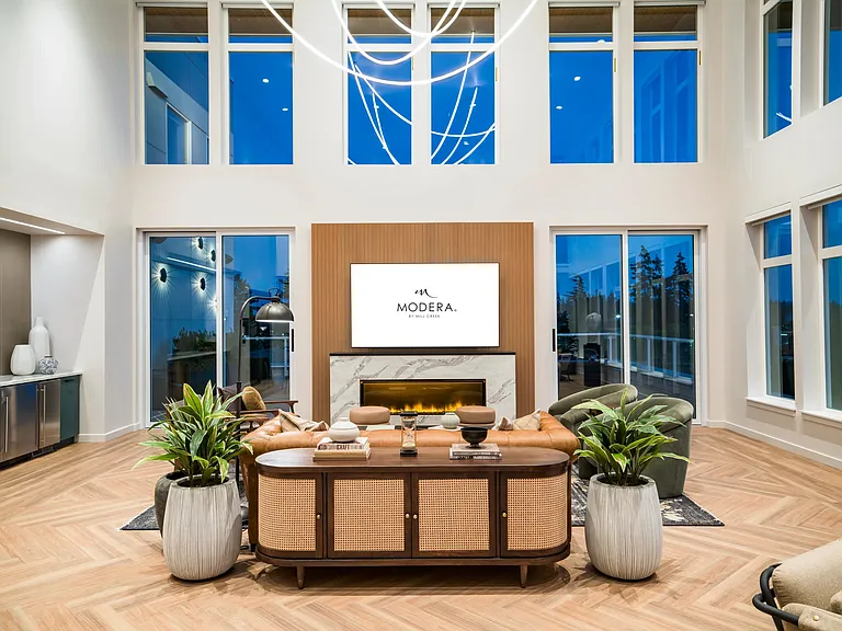 Expansive windows and refined finishes make Modera Shoreline's lounge a bright, welcoming retreat perfectly suited for gatherings or quiet evenings in.