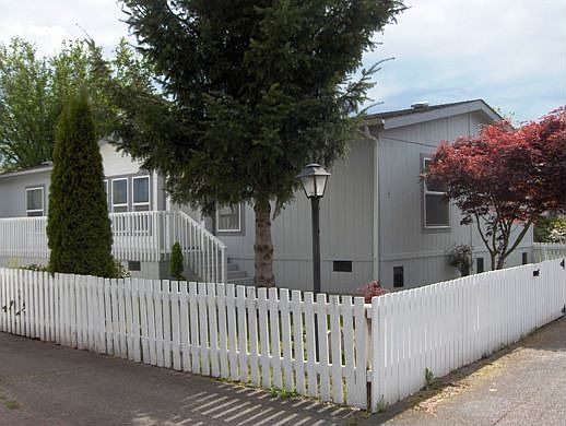 Corner of house showing entry beyond lamp post