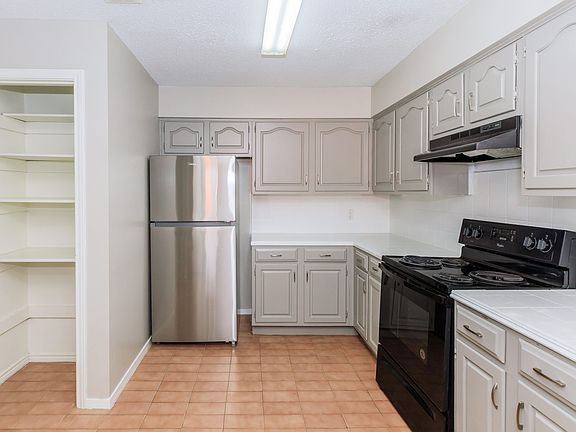 Huge kitchen with lots of cabinets and a pantry
