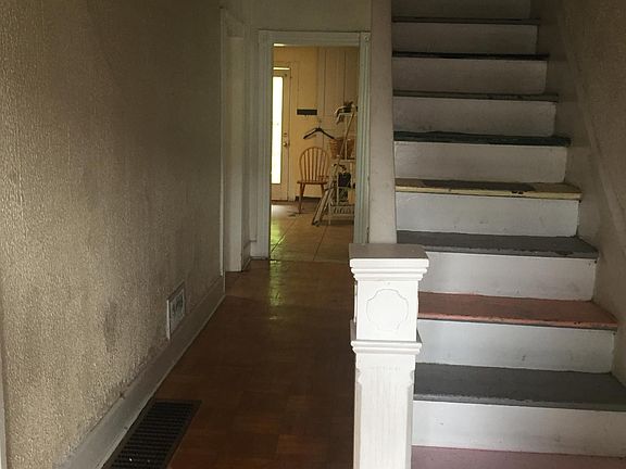 Stairs to the bedrooms and hallway to kitchen