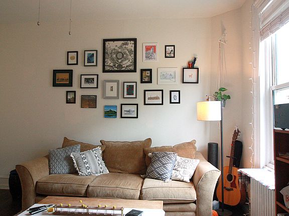Living room has a new ceiling fan, hardwood floors, and views of Pine Street