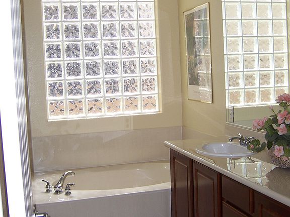 Master Bath with dual sinks, seperate tub and shower and glass block window!