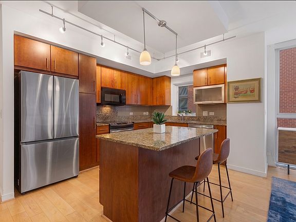 Cook in style in this modern kitchen equipped with premium stainless steel appliances and ample counter space.