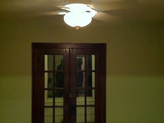 Living room double doors lead to the screened-in front porch