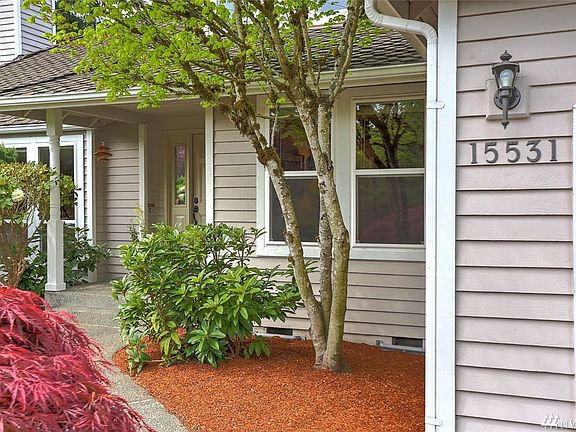 Delight in this gracious approach to the front door with mature landscaping and seasonal blooms to greet you. Located in the sou