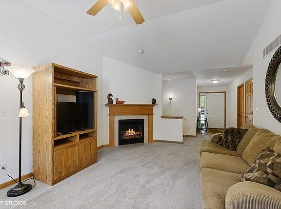 Spacious living room with a gas log fireplace to enjoy with decorative wood surround!