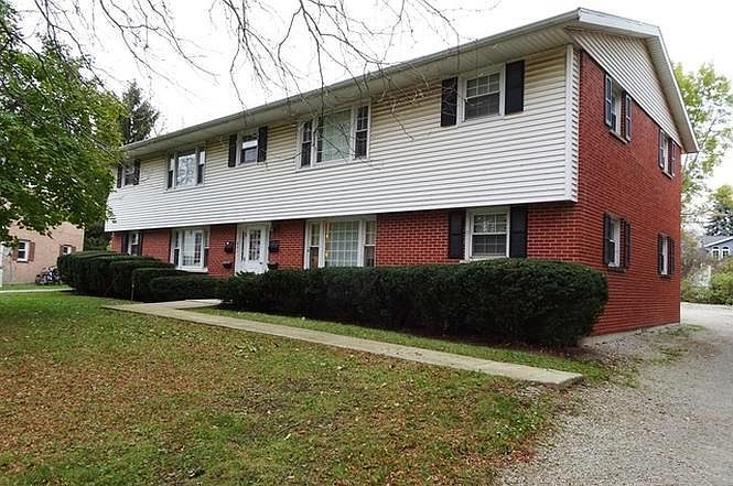 Front of building, access usually made through back which now has a new safe solid core steel door. Parking in back for at least 1 car, street parking available as well.